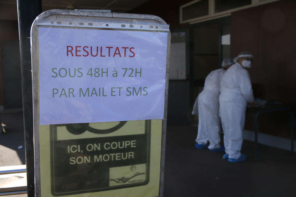 A technician wash their hands after collecting nasal swab samples for COVID-19 at a drive-through testing centre where results are expected with 2 or 3 days, in Wambrechies, northern France, Monday, Sept.21, 2020. Coronavirus infections tipped the scales again in France on Saturday with nearly 13,500 new infections in 24 hours. (AP Photo/Michel Spingler)