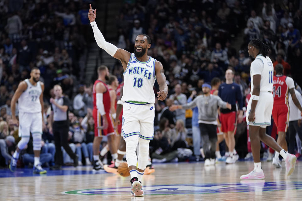 Minnesota Timberwolves guard Mike Conley (10) celebrates after a basket made by center Rudy Gobert during the first half of an NBA basketball game against the New Orleans Pelicans, Wednesday, Nov. 8, 2023, in Minneapolis. (AP Photo/Abbie Parr)