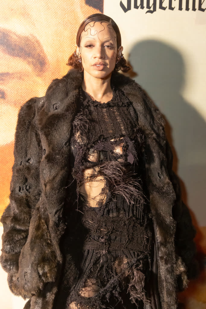 Dascha in an artistically torn dress and fur coat on the red carpet