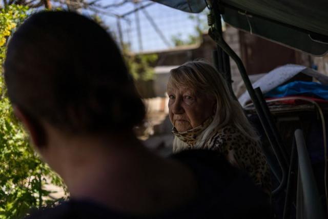 Valentyna Haras, 74, looks on at her home garden in Kherson