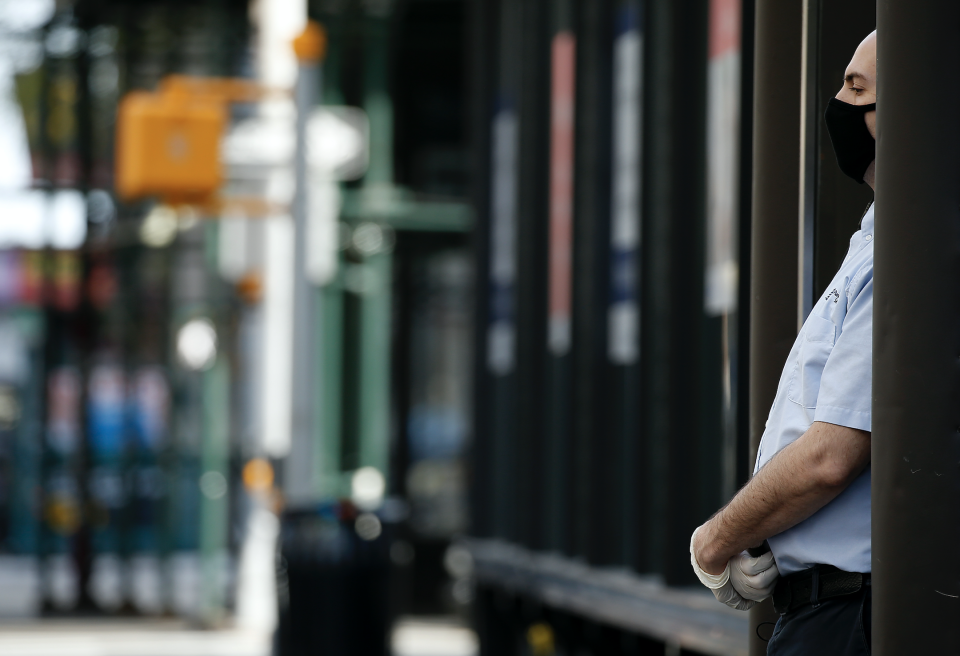 A man with gloves and mask stands in the door of his store amid the coronavirus pandemic on April 7, 2020 in New York City.  (Photo: John Lamparski/Getty Images) 