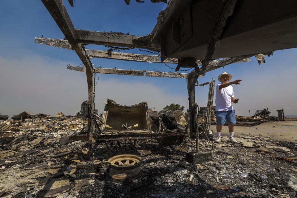 Roland Pagan survey remains of his home burned to ground by the Bobcat Fire on Juniper Hills Drive in Little Rock.