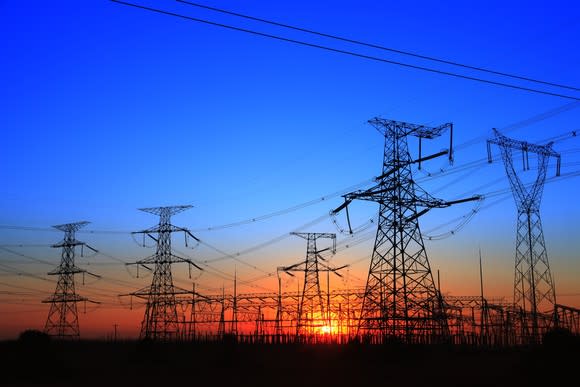 The silhouette of the evening electricity transmission pylon.