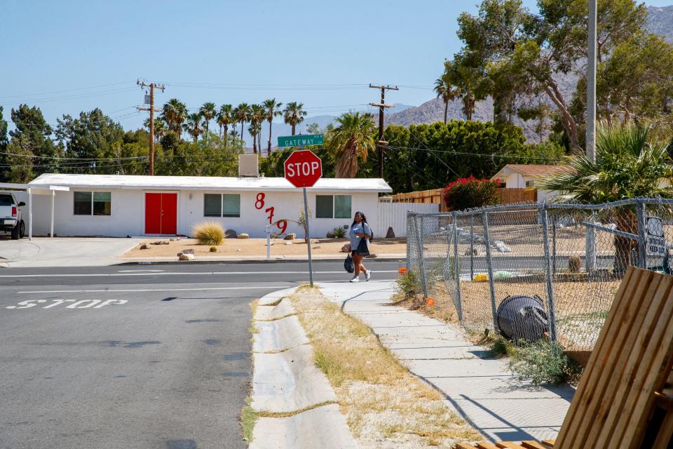 A woman walks along Gateway Drive in the historically Black neighborhood of Desert Highland Gateway Estates in Palm Springs, Calif., on May 23, 2022. 