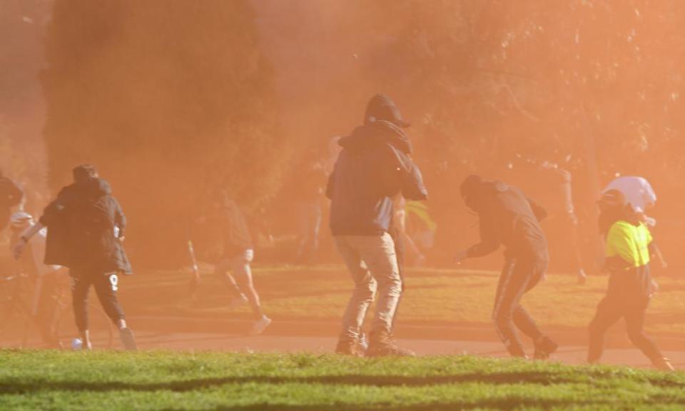 Protesters flee as police break up the rally at the Shrine of Remembrance.