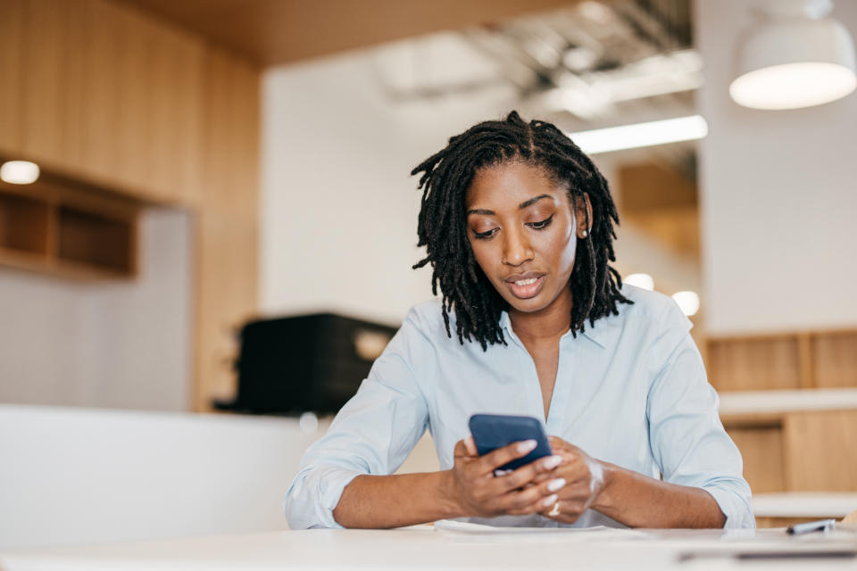 Women using cellphone to read advanced investing content covering concepts like tax loss harvesting and technical analysis of stocks