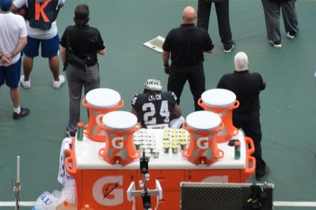 Nov 19, 2017; Mexico City, MEX; Oakland Raiders running back Marshawn Lynch (24) sits behind the bench during the playing of the United States national anthem before an NFL International Series game against the New England Patriots at Estadio Azteca. The Patriots defeated the Raiders 33-8. Kirby Lee-USA TODAY Sports