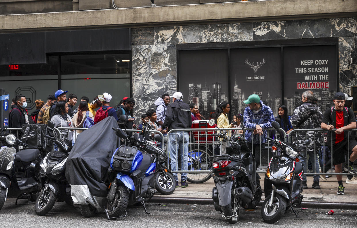 Asylum seekers line up in front of the Roosevelt Hotel, converted into a city-run shelter for newly arrived migrant families in New York City, on September 27.