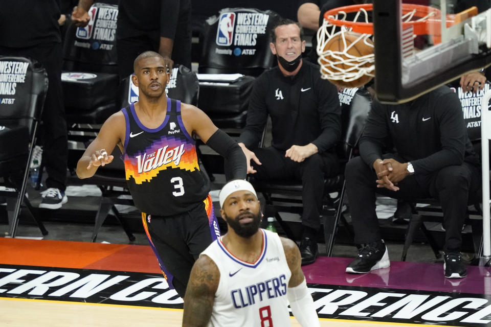 Phoenix Suns guard Chris Paul (3) watches his shot go through the hoop as Los Angeles Clippers forward Marcus Morris Sr. (8) looks on during the first half of game 5 of the NBA basketball Western Conference Finals, Monday, June 28, 2021, in Phoenix. (AP Photo/Matt York)