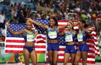 <p>(L-R) Natasha Hastings, Phyllis Francis, Allyson Felix and Courtney Okolo of the United States react after winning gold in the Women’s 4 x 400 meter Relay on Day 15 of the Rio 2016 Olympic Games at the Olympic Stadium on August 20, 2016 in Rio de Janeiro, Brazil. (Photo by Cameron Spencer/Getty Images) </p>