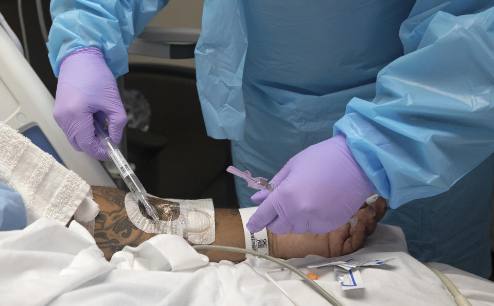 A nurse injects steroids into COVID-19 patient Cedric Daniels, 37, of Gonzales, La., as he recuperates at Our Lady of the Lake Regional Medical Center in Baton Rouge, Monday, Aug. 2, 2021. Louisiana is leading the nation in the number of new COVID cases per capita and remains one of the bottom five states in administering vaccinations. (AP Photo/Ted Jackson)