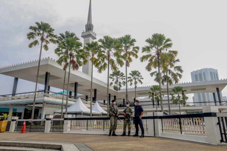 Police and Armed Forces personnel patrol the perimeter of the National Mosque, Kuala Lumpur May 24, 2020 — Picture by Firdaus Latif