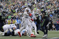 Tennessee Titans running back Derrick Henry, 22, scores a touchdown against the Seattle Seahawks during the second half of an NFL football game, Sunday, Sept. 19, 2021, in Seattle. The extra point was good and the score tied the game at 30-30. (AP Photo/John Froschauer)