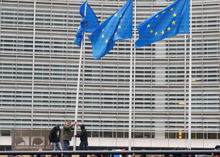 Far-right supporters attempt to dismantle the EU flag mast at European Commission headquarters during a protest against Marrakesh Migration Pact in Brussels, Belgium December 16, 2018. REUTERS/Francois Lenoir