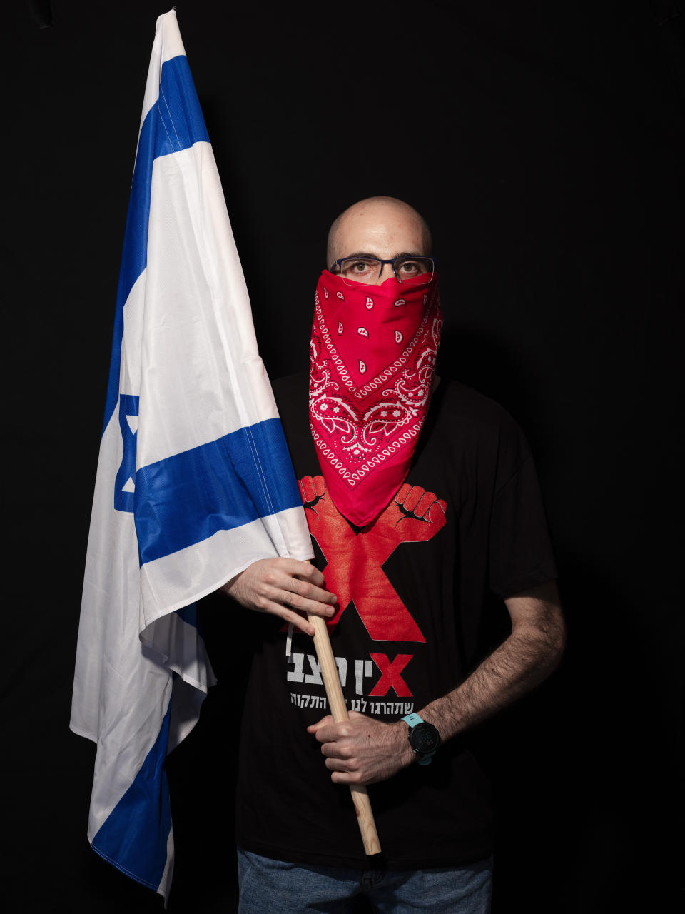 Dekel Gilag, 25, poses for a photo during a protest against Israel's Prime Minister Benjamin Netanyahu, outside his residence in Jerusalem, Thursday, July 23, 2020. The wave of colorful and combative demonstrations against Netanyahu and his perceived failure to handle the country's deepening economic crisis have been characterized by youth. With flags, facemasks, drums, placards and an assortment of props, thousands have been taking to the streets to demand change in a variety of unique ways. (AP Photo/Oded Balilty)