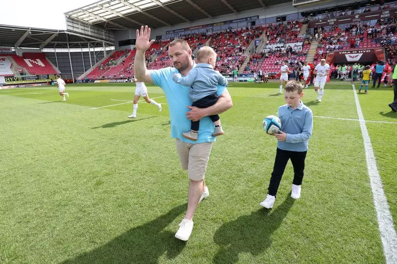 Ken Owens walks onto the field at Parc y Scarlets with his children for a final time. -Credit:Huw Evans Picture Agency