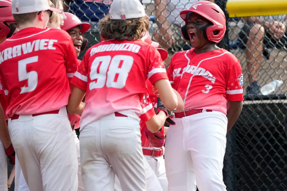 Jason Ballard (right) celebrates with his Holbrook Little League teammates after hitting a three-run home-run in the first inning. The Jackson Township team went on to beat East Hanover, 12-2 in four innings. Thursday, July 27, 2023