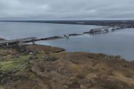 General view of the damaged Antonivsky Bridge in Kherson, Ukraine, Sunday, Nov. 27, 2022. The bridge, the main crossing point over the Dnipro river in Kherson, was destroyed by Russian troops in earlier November, after Kremlin's forces withdrew from the southern city. (AP Photo/Bernat Armangue)