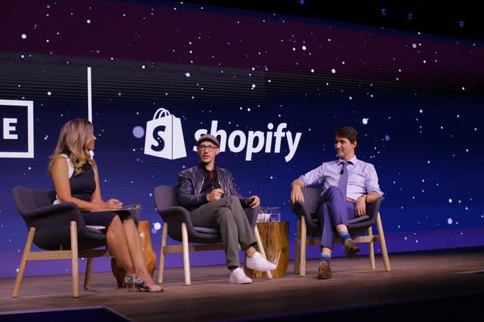 Shopify's CEO speaking on a stage alongside Canada's prime minister.