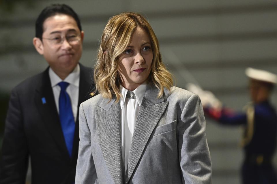 Italian Premier Giorgia Meloni, center, attends inspects an honor guard with Japanese Prime Minister Fumio Kishida during a welcoming ceremony prior their meeting at the prime minister's office in Tokyo on Monday, Feb. 5, 2024. (David Mareuil/Pool Photo via AP)