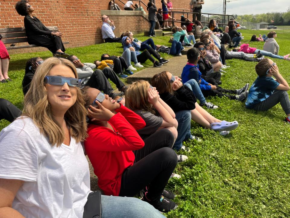 (Left) Librarian Pam Bryant and Serenity Goodman watch the eclipse together on April 8, 2024 at Riverside Elementary in Columbia, Tenn.