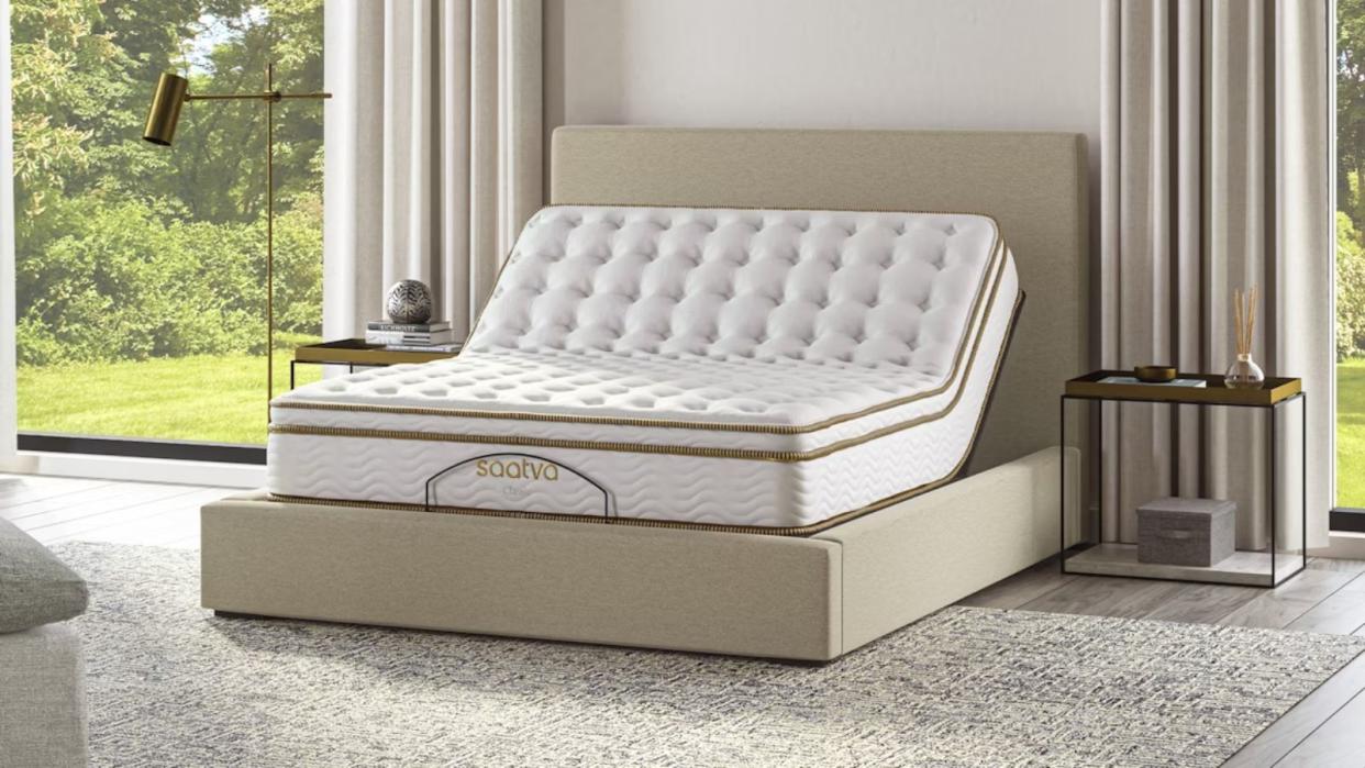  A Saatva adjustable bed base with a Saatva mattress in a modern bedroom 