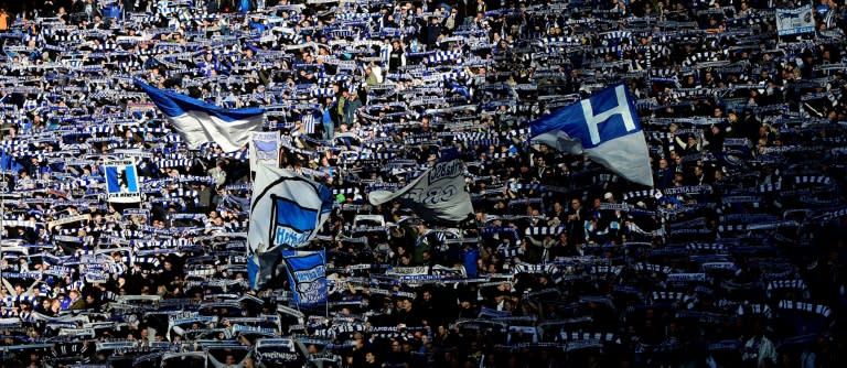 Hertha Berlin's supporters wave flags at their Bundesliga football match against Borussia Dortmund in Berlin, Germany, on March 11, 2017