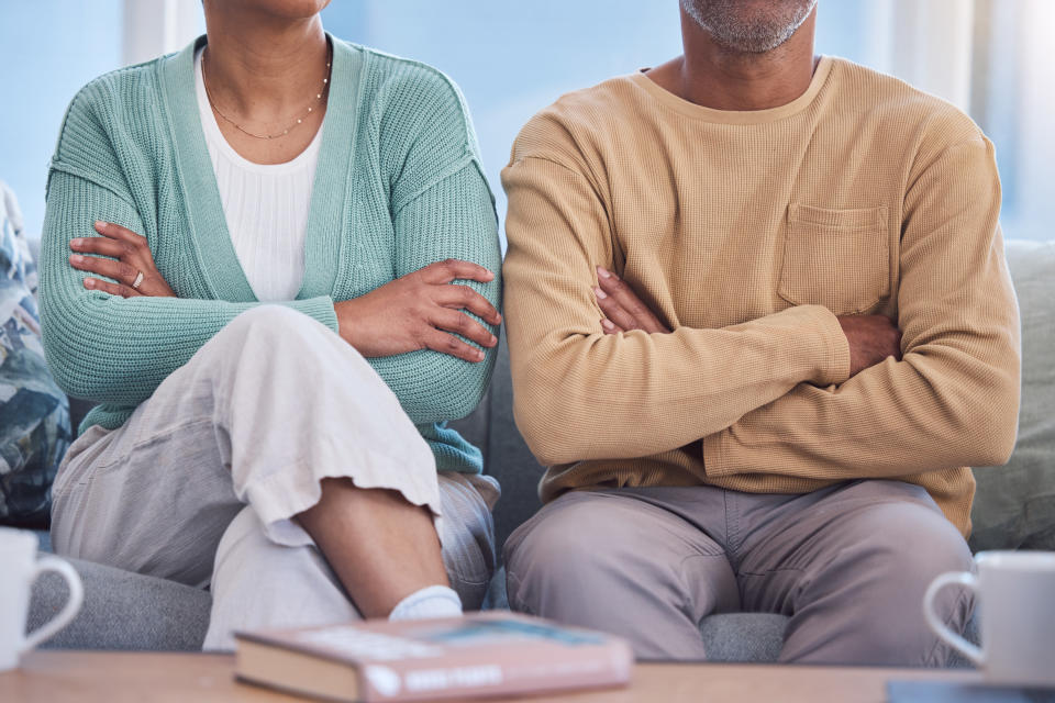 couple sitting next to each other with their arms folded