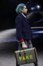 A model wears a creation as part of the Gucci men's Fall-Winter 2020/21 collection, that was presented in Milan, Italy, Tuesday, Jan. 14, 2020. (AP Photo/Luca Bruno)