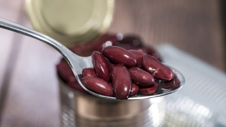 kidney beans in open can with spoon