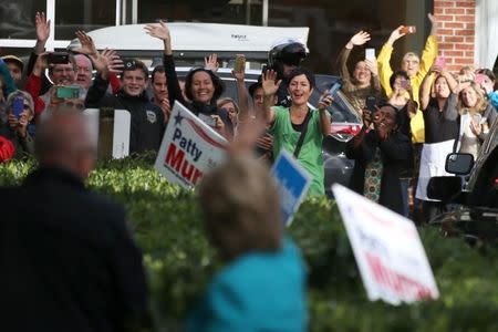 Supporters wave as U.S. Democratic presidential nominee Hillary Clinton arrives at a campaign office in Seattle, Washington, U.S. October 14, 2016. REUTERS/Lucy Nicholson