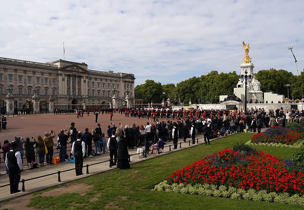 LONDON, ENGLAND - SEPTEMBER 19: The Queen's funeral cortege borne on the State Gun Carriage of the Royal Navy travels past the Queen Victoria Memorial outside of Buckingham Palace on September 19, 2022 in London, England. Elizabeth Alexandra Mary Windsor was born in Bruton Street, Mayfair, London on 21 April 1926. She married Prince Philip in 1947 and ascended the throne of the United Kingdom and Commonwealth on 6 February 1952 after the death of her Father, King George VI. Queen Elizabeth II died at Balmoral Castle in Scotland on September 8, 2022, and is succeeded by her eldest son, King Charles III.  (Photo by Ian Forsyth/Getty Images)