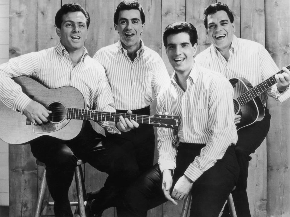 circa 1965:  Promotional portrait of the American pop group The Four Seasons. From left: Tommy DeVito, Frankie Vali, Bob Gaudio, and Nick Massi. The band members are dressed identically in light striped shirts and black pants.  (Photo by Hulton Archive/Getty Images)