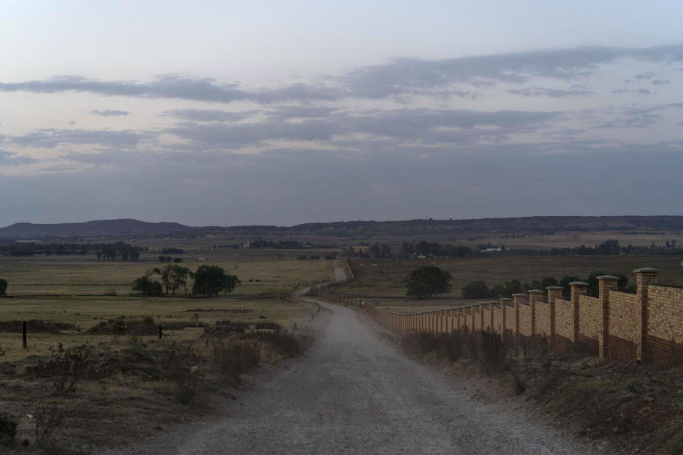 This Wednesday, Oct. 3, 2018 photo, shows the road leading to the Olifantsvlei cemetery outside Johannesburg. At the graveyard unidentified bodies are buried in "pauper graves." (AP Photo/Bram Janssen)