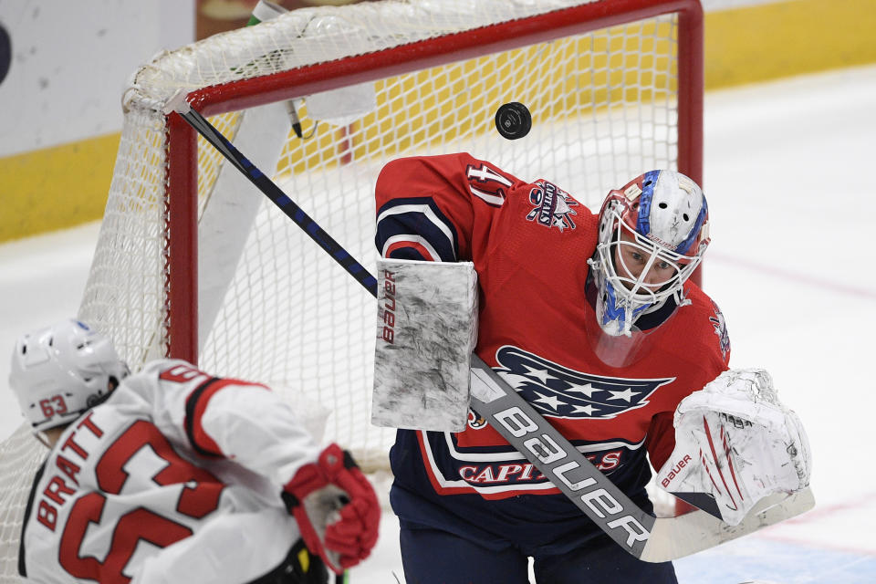 Washington Capitals goaltender Vitek Vanecek (41) deflects the puck on a shot by New Jersey Devils left wing Jesper Bratt (63) during the second period of an NHL hockey game Tuesday, March 9, 2021, in Washington. (AP Photo/Nick Wass)