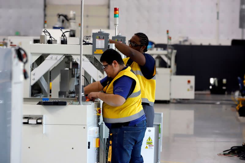 FILE PHOTO: SunPower equipment technicians install P-Series solar panel manufacturing technology at its Hillsboro manufacturing plant in Hillsboro