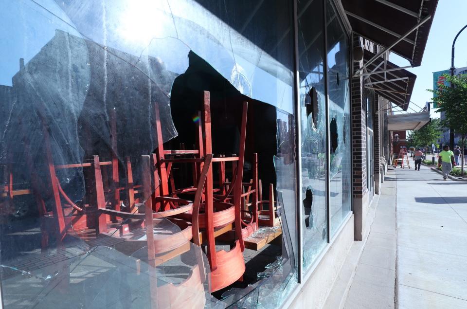 Windows remain broken Monday at the former Bricco restaurant during protests the night before in downtown Akron.