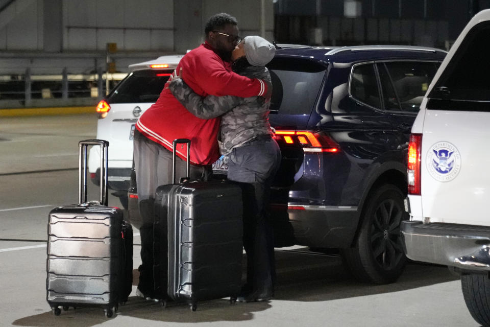 A man and woman hug each other at the O'Hare International Airport in Chicago, Thursday, Dec. 21, 2023. It's beginning to look a lot like a hectic holiday travel season, but it might go relatively smoothly if the weather cooperates. (AP Photo/Nam Y. Huh)