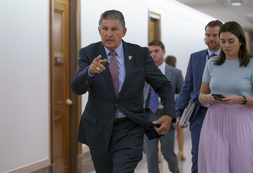 Sen. Joe Manchin, D-W.Va., is met by reporters outside the hearing room where he chairs the Senate Committee on Energy and Natural Resources, at the Capitol in Washington, Tuesday, July 19, 2022. (AP Photo/J. Scott Applewhite)