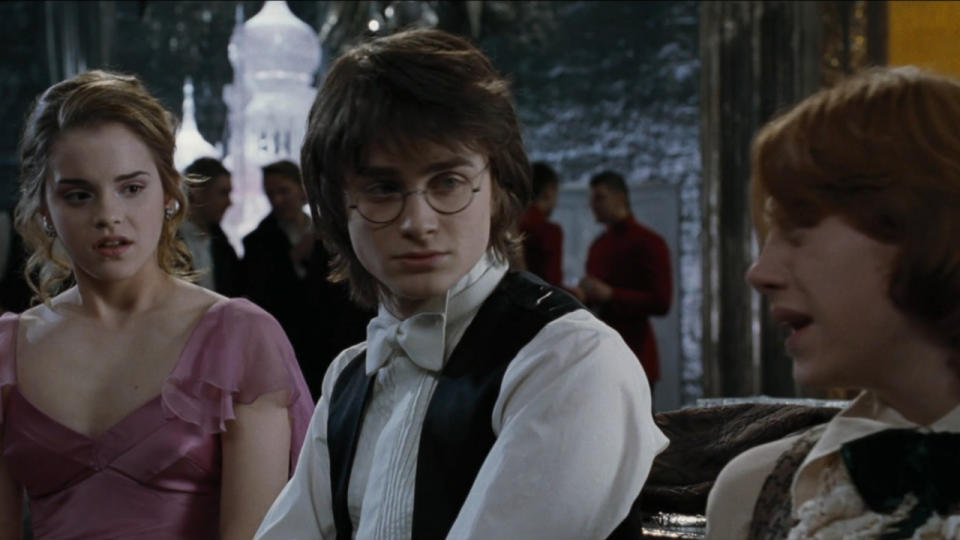 Daniel Radcliffe sits uncomfortably between a fighting Emma Watson and Rupert Grint at the Yule Ball in Harry Potter and the Goblet of Fire.