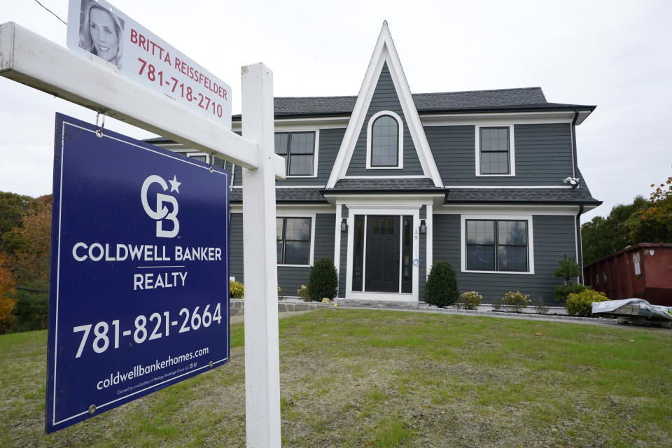 A real estate sign hangs in front of a home, Tuesday, Oct. 27, 2020, in Westwood, Mass. President-elect Joe Biden will inherit a mangled U.S. economy, one that never fully healed from the coronavirus and could suffer again as new infections are climbing. The once robust recovery has shown signs of gasping after federal aid lapsed. Ten million remain jobless and more layoffs are becoming permanent. The Federal Reserve found that factory output dropped. (AP Photo/Steven Senne)