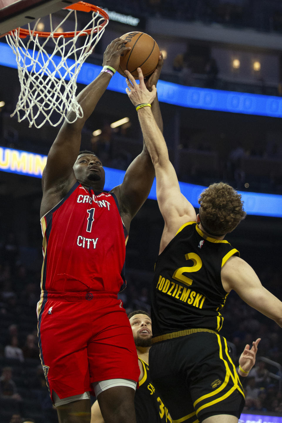 New Orleans Pelicans forward Zion Williamson (1) grabs an offensive rebound over Golden State Warriors guard Brandin Podziemski (2) during the first quarter of an NBA basketball game, Wednesday, Jan. 10, 2024, in San Francisco. (AP Photo/D. Ross Cameron)