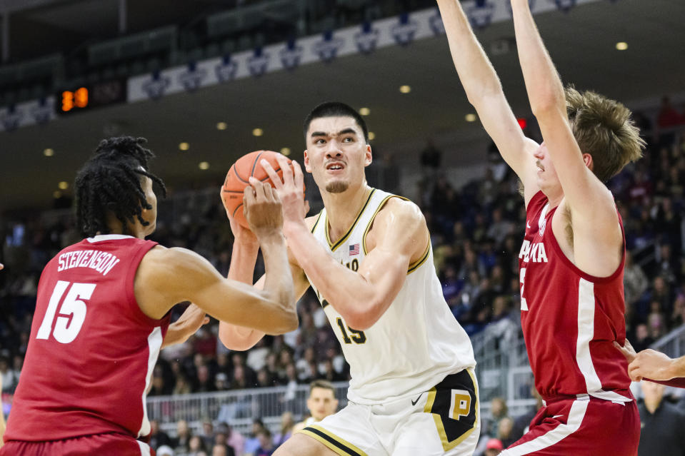 Purdue center Zach Edey (15) is defended by Alabama forward Jarin Stevenson (15) and Alabama forward Grant Nelson (2) during the second half of an NCAA college basketball game in Toronto, Saturday, Dec. 9, 2023. (Christopher Katsarov/The Canadian Press via AP)