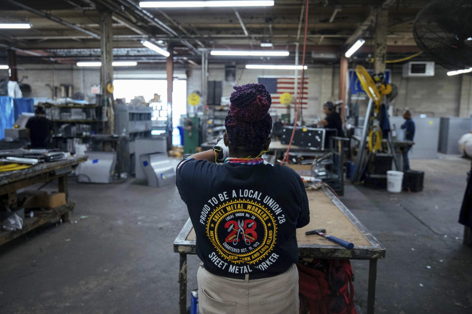 Sheet metal worker Carey Mercer assembles ductwork at Contractors Sheet Metal on Tuesday, Aug. 3, 2021, in New York. The construction industry is fighting to recruit more women into a sector that faces chronic labor shortages. Women make up only 4% of skilled construction laborers in the U.S. and often face discrimination on jobs sites. (AP Photo/Kevin Hagen)