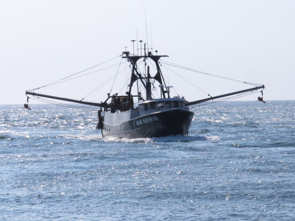 In this Sept. 11, 2019 photo, the commercial fishing boat Ann Kathryn sails into the Manasquan Inlet in Manasquan, N.J. Although they support effort to fight climate change and its impact on the world's oceans, the fishing industry fears it could be harmed by one of the promising solutions: the offshore wind energy industry. At a Congressional subcommittee hearing Monday Sept. 16, 2019 in New Jersey, fishermen asked for a seat at the table when important wind energy decisions are made, including where projects are located. (AP Photo/Wayne Parry)