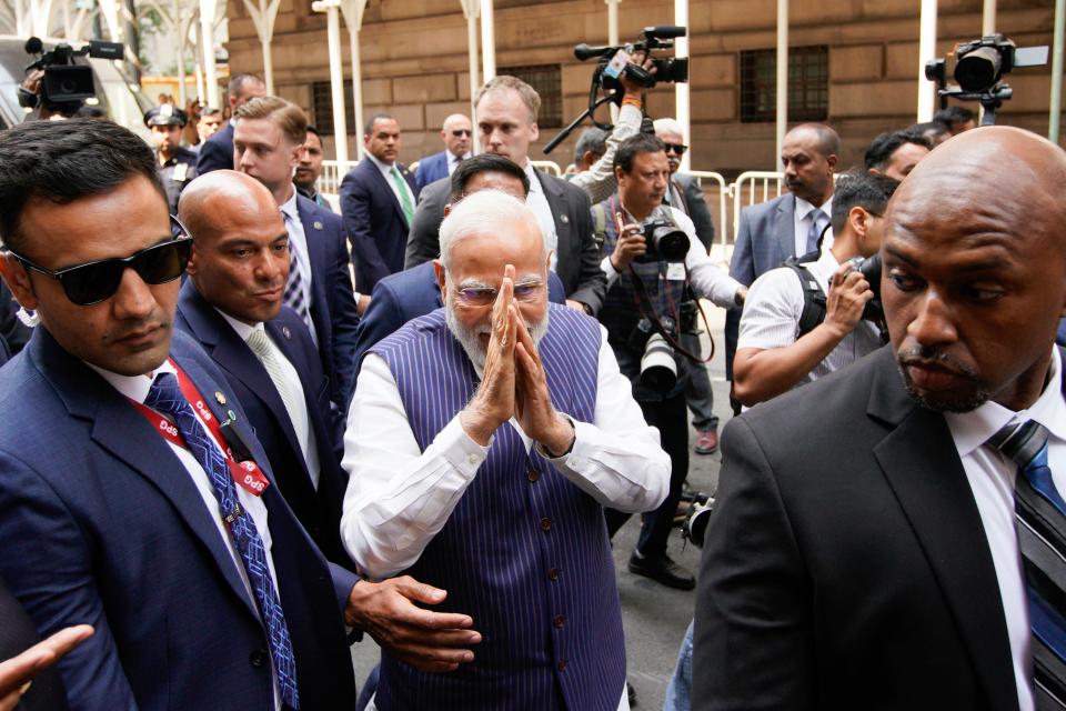 Indian Prime Minister Narendra Modi greets supporters as he arrives in New York on Tuesday, June 20, 2023.