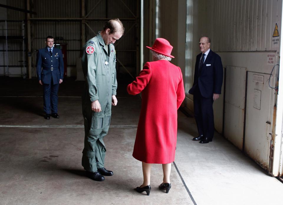 Queen Elizabeth talks with her grandson, Prince William.