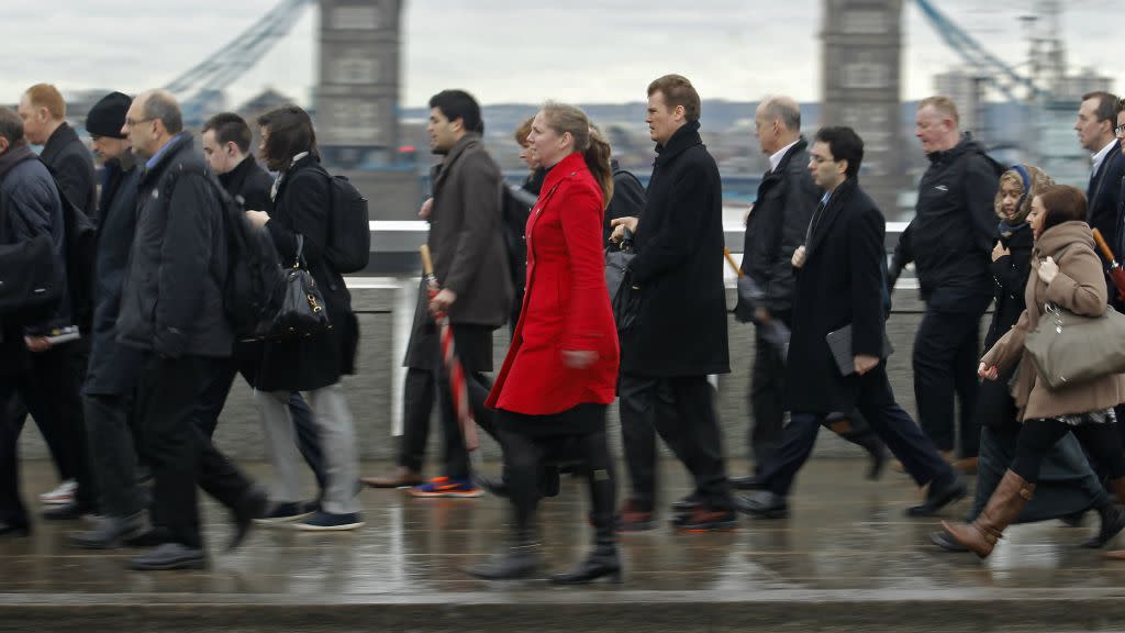 Commuters crossing London Bridge on way to work.