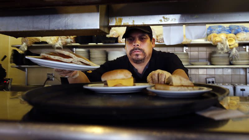 Boni Contreras cooks meals at the Denny’s in Layton in 2014. Denny’s is one of several restaurants that keeps its doors open on Thanksgiving.