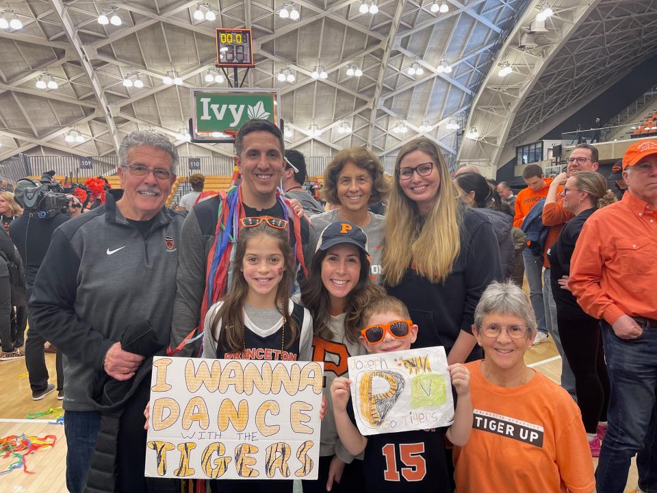 Chris Mongilia, standing, second from left, joins his family after the Tigers won the Ivy League basketball tournament.